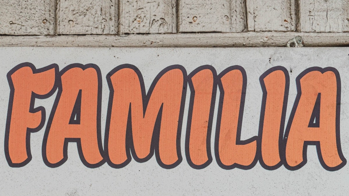 a white sign with orange writing on it